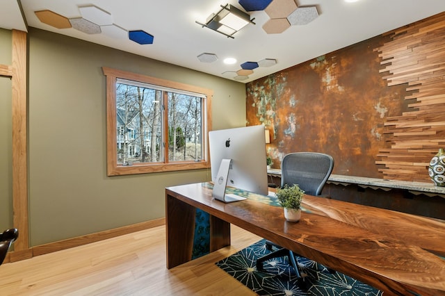 office area with baseboards and wood finished floors