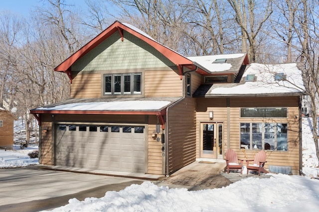 chalet / cabin with a garage and driveway