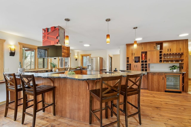 kitchen with brown cabinets, open shelves, light wood finished floors, wine cooler, and stainless steel refrigerator with ice dispenser