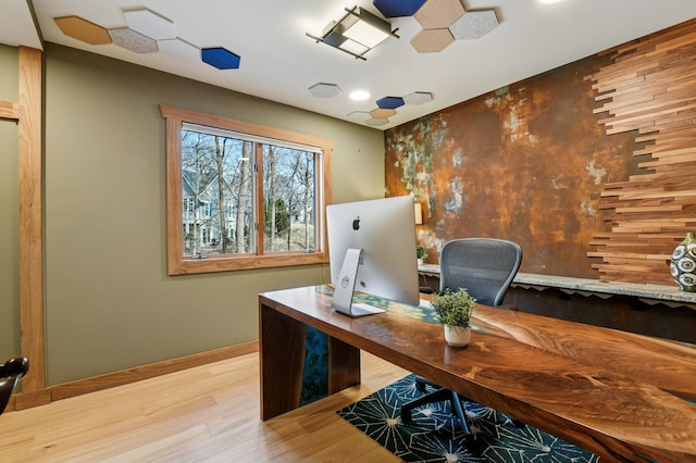 home office featuring baseboards and wood finished floors