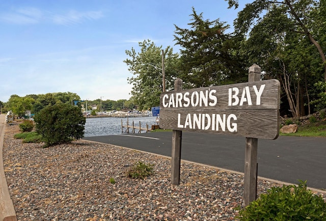 community / neighborhood sign with a water view