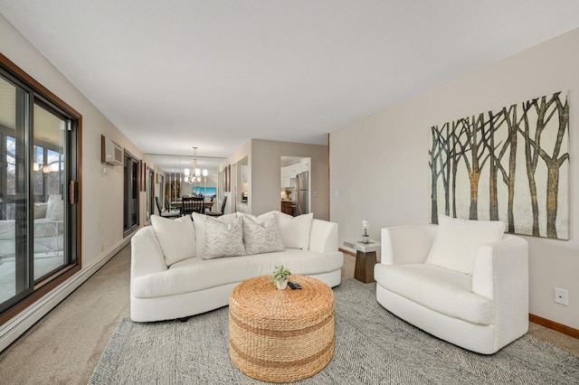 carpeted living room with a chandelier, baseboard heating, and baseboards