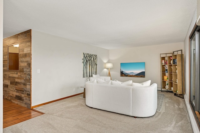 living area with baseboards and carpet flooring