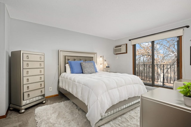 carpeted bedroom with access to outside, baseboards, and a wall mounted air conditioner