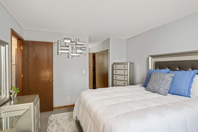 bedroom featuring baseboards and carpet flooring