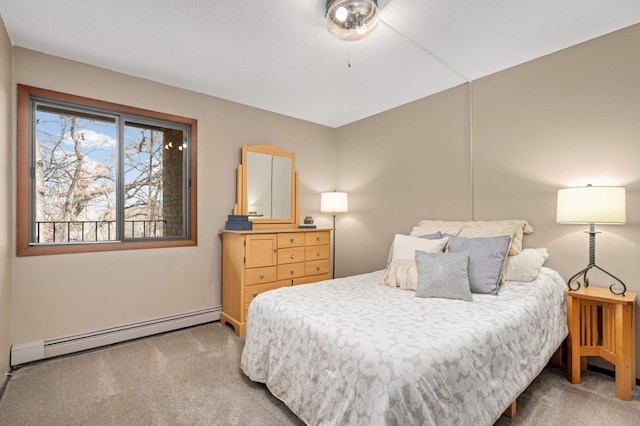 bedroom with a baseboard radiator and carpet flooring