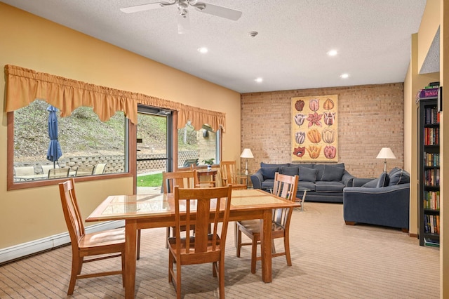 dining room with a textured ceiling, recessed lighting, brick wall, and ceiling fan