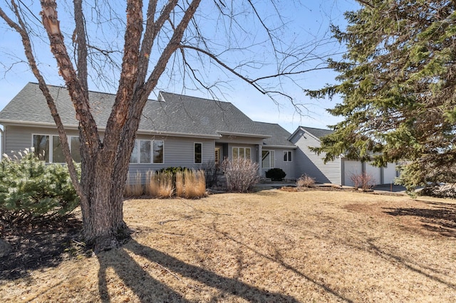 rear view of property with a shingled roof