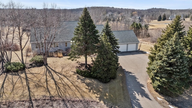 drone / aerial view featuring a wooded view