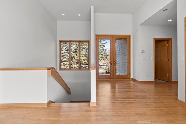 foyer featuring recessed lighting, french doors, baseboards, and wood finished floors