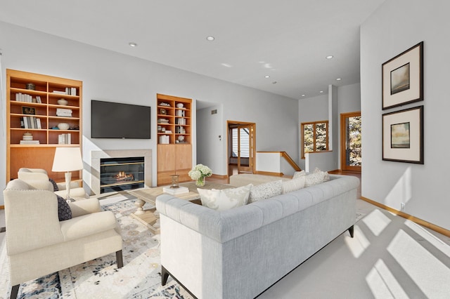 carpeted living room featuring a wealth of natural light, built in features, recessed lighting, and baseboards