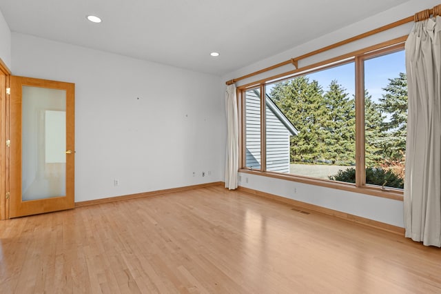 unfurnished room featuring light wood finished floors, recessed lighting, and a wealth of natural light