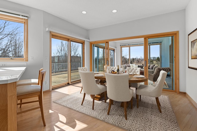 dining area with recessed lighting, light wood-style floors, and baseboards