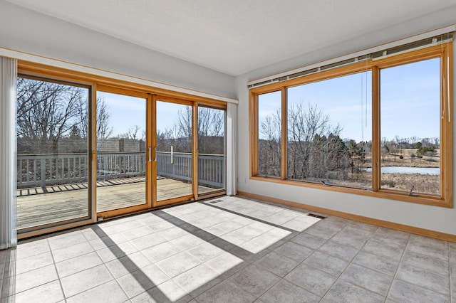 unfurnished sunroom featuring a wealth of natural light