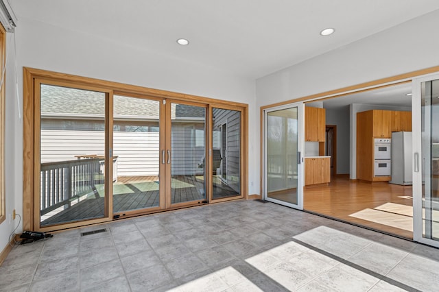 unfurnished sunroom with visible vents