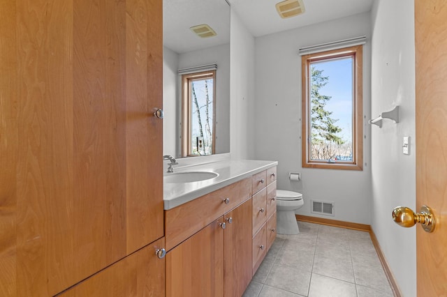 bathroom featuring tile patterned flooring, visible vents, toilet, and baseboards