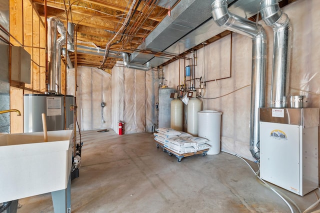 unfinished below grade area featuring a sink and water heater