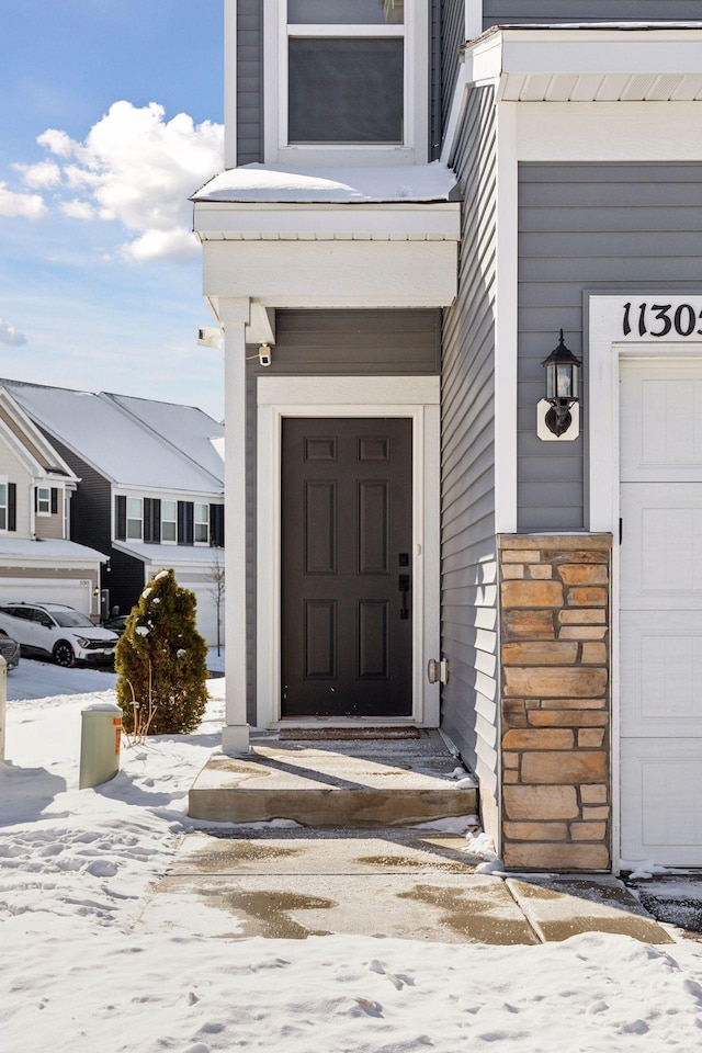 view of snow covered property entrance