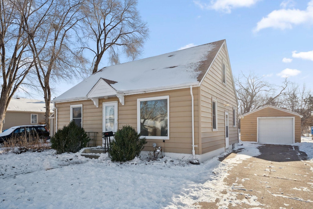 bungalow-style house featuring an outbuilding and a garage