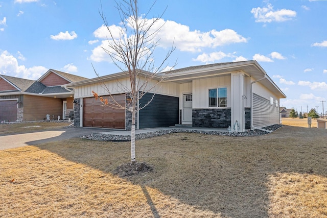 single story home featuring board and batten siding, a front yard, a garage, stone siding, and driveway