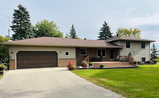 view of front facade featuring a garage, a front yard, and a deck