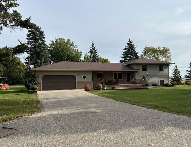 view of front of house featuring a wooden deck, a garage, and a front yard