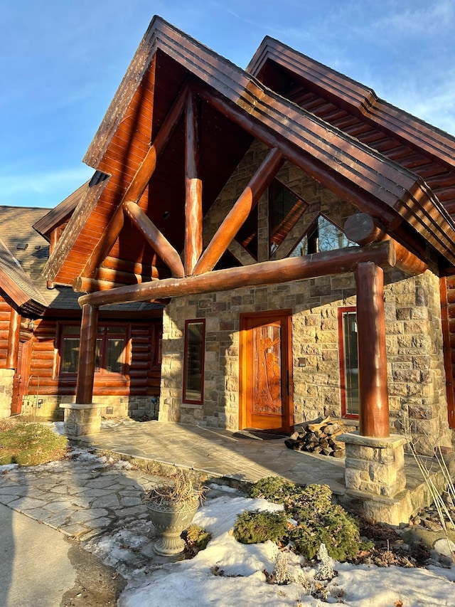 doorway to property with stone siding