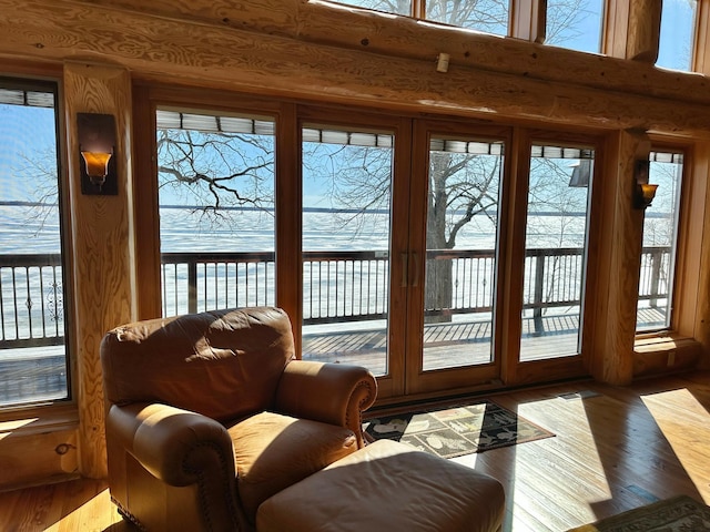 doorway with log walls and wood finished floors