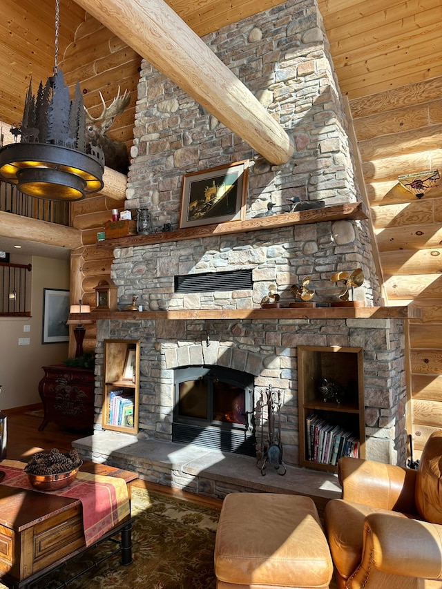 living area featuring rustic walls, a stone fireplace, a high ceiling, and wood finished floors