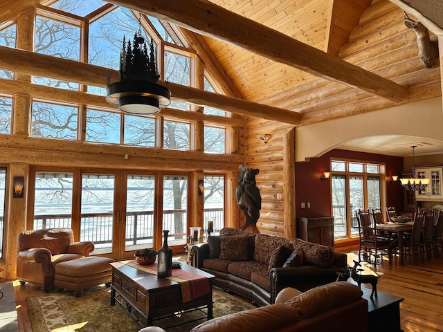 living area featuring beam ceiling, wooden ceiling, arched walkways, and wood-type flooring