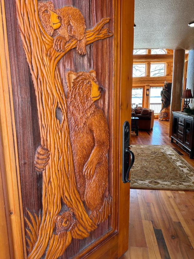 hallway featuring a textured ceiling and hardwood / wood-style flooring