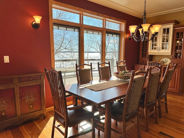 dining space with a notable chandelier and light wood-style flooring