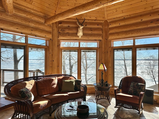 sunroom featuring lofted ceiling, plenty of natural light, and wood ceiling