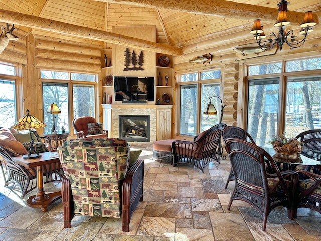 living area featuring stone tile flooring, wooden ceiling, and high vaulted ceiling