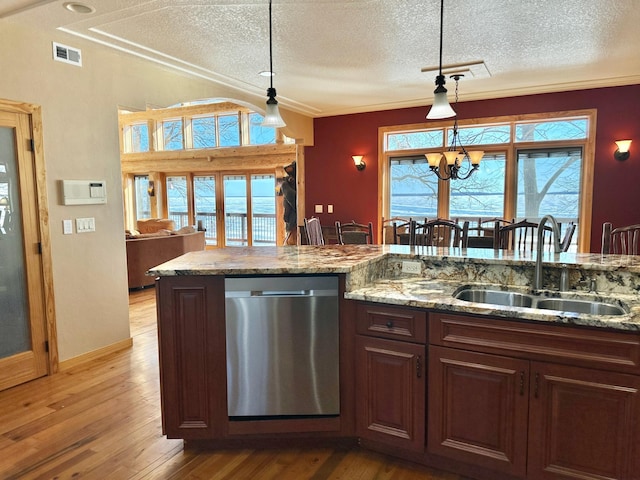 kitchen featuring light wood-type flooring, pendant lighting, a sink, plenty of natural light, and stainless steel dishwasher