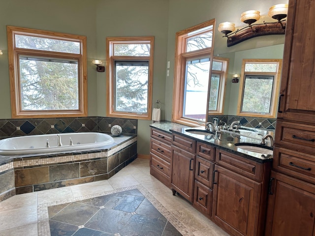 full bathroom featuring a sink, tasteful backsplash, a garden tub, and double vanity