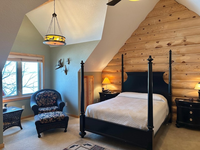 bedroom featuring lofted ceiling, carpet flooring, and log walls