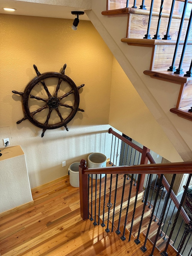 stairway with wood finished floors