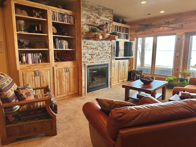 living area with recessed lighting, a fireplace, visible vents, and light carpet