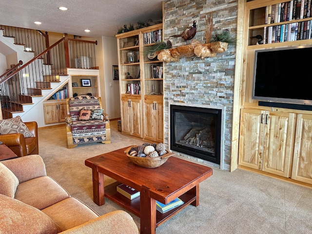 living room featuring stairway, carpet flooring, recessed lighting, a fireplace, and a textured ceiling