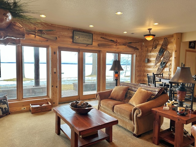 living area with rustic walls, light carpet, recessed lighting, and a textured ceiling