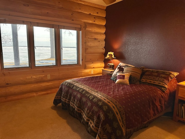 carpeted bedroom featuring a textured wall and log walls