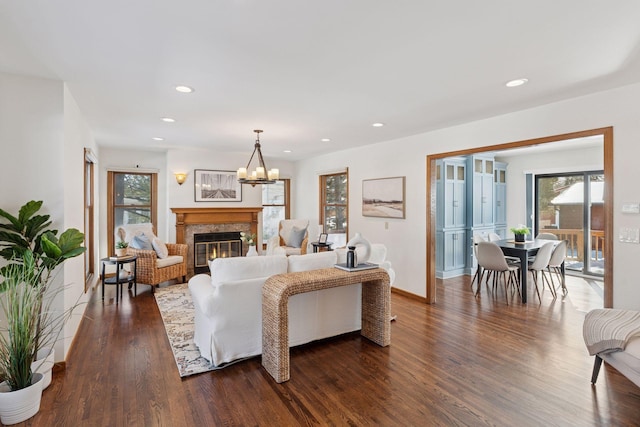 living room with a high end fireplace, recessed lighting, baseboards, and dark wood-style flooring