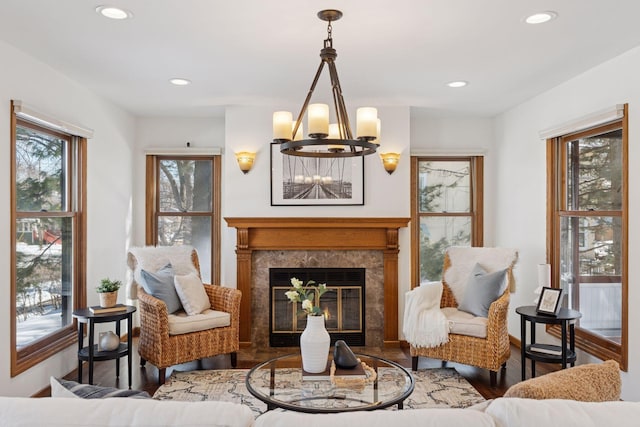 sitting room featuring wood finished floors, a notable chandelier, recessed lighting, and a fireplace