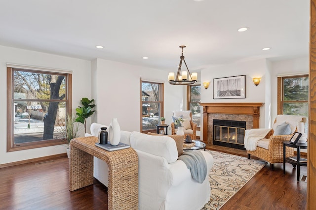 living room with recessed lighting, baseboards, dark wood-style flooring, and a fireplace