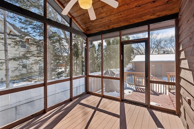 unfurnished sunroom featuring a wealth of natural light, wood ceiling, ceiling fan, and vaulted ceiling