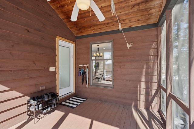 unfurnished sunroom with ceiling fan with notable chandelier, wood ceiling, and vaulted ceiling