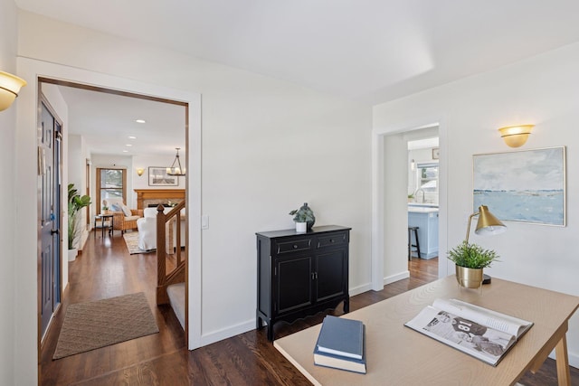 home office with a sink, recessed lighting, baseboards, and dark wood-style flooring