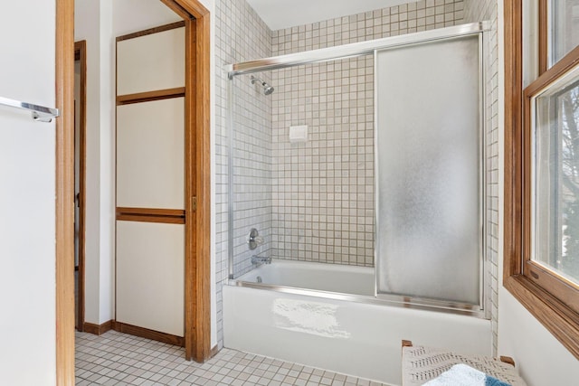 full bath with tile patterned floors and shower / bath combination with glass door