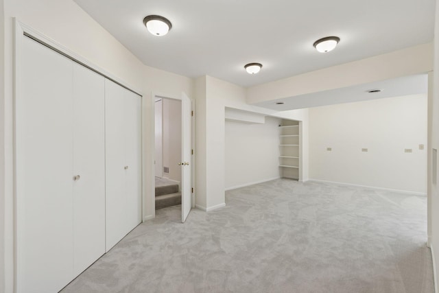 finished basement with baseboards and light colored carpet